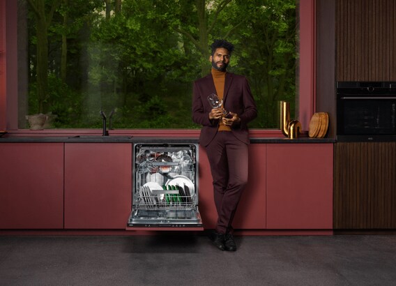 Man standing next to dishwasher